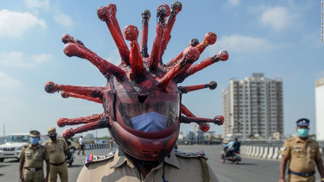 Indian Police officer wears coronaavirus face mask to force people to stay hom during lockdown