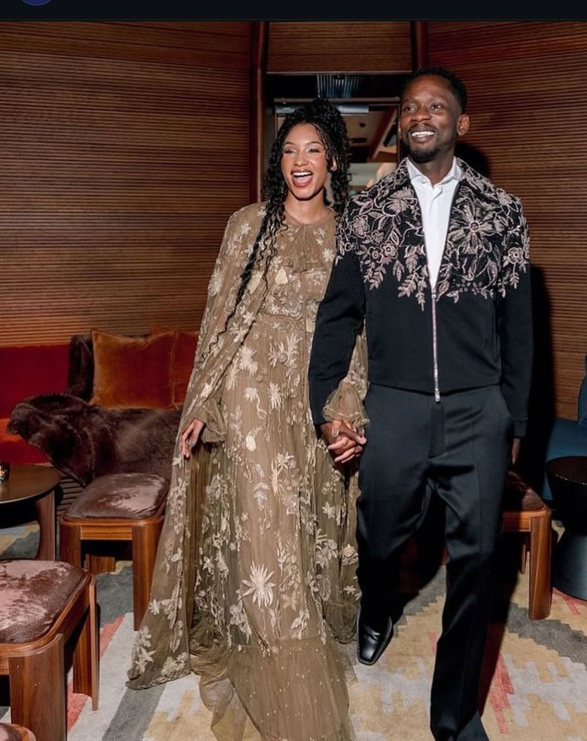 Mr Eazi and Temi Otedola smiling together, showcasing their stylish and playful celebrity marriage