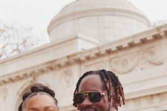 Mr Eazi and Temi Otedola smiling together, showcasing their stylish and playful celebrity marriage